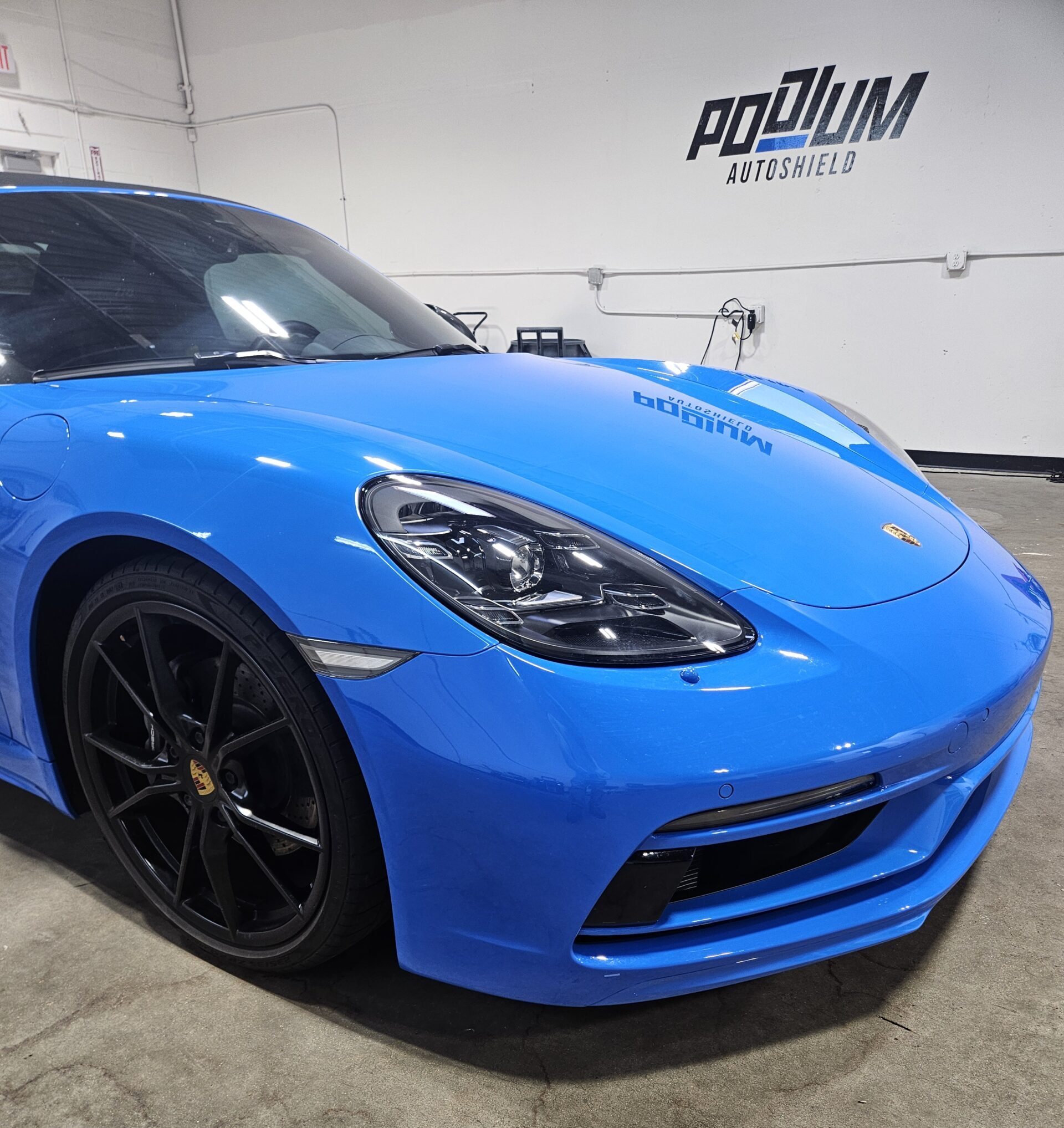 Blue Porsche Carrera 911 GTS protected with 3M paint protection film at Podium AutoShield